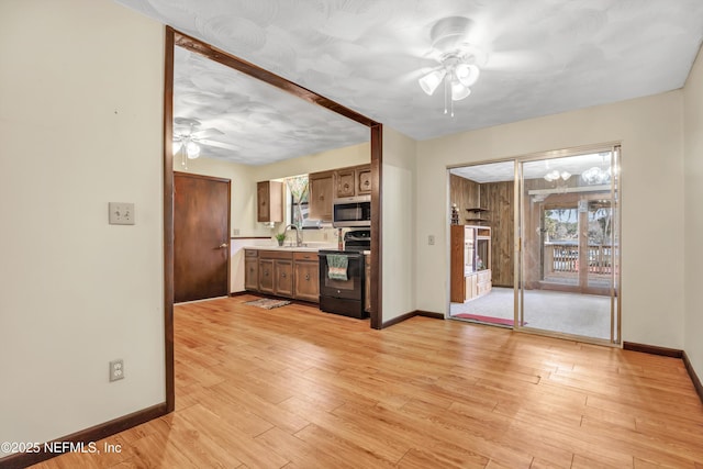 1019 Haynes Ct, Green Cove Springs, FL 32043 - kitchen with sink, black electric range, ceiling fan, and light wood-type flooring