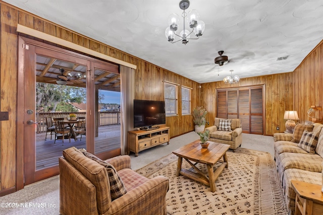 1019 Haynes Ct, Green Cove Springs, FL 32043 - living room with an inviting chandelier, light colored carpet, and wood walls