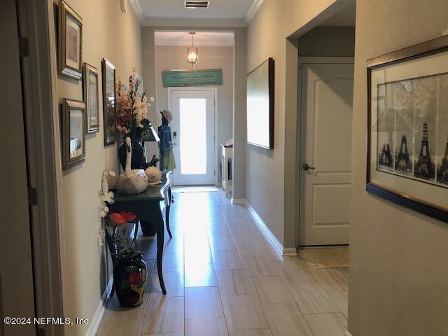 corridor featuring ornamental molding