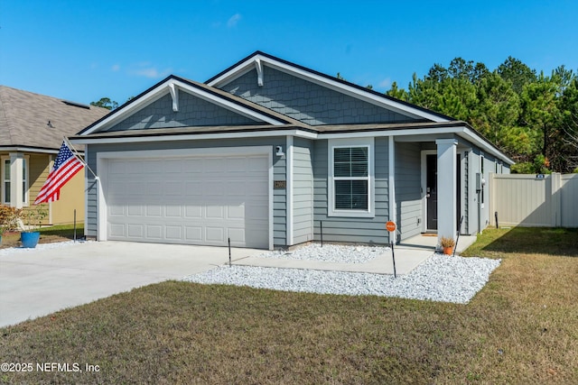 view of front of property featuring a garage and a front lawn