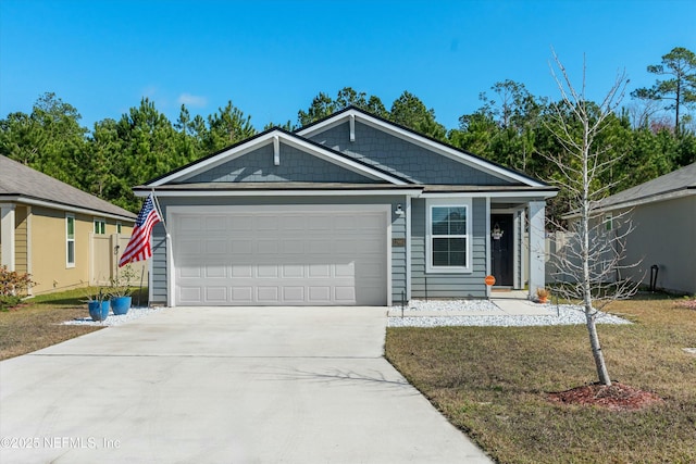 view of front of house featuring a garage and a front lawn