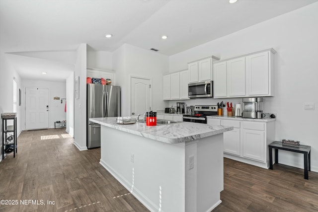 kitchen featuring sink, stainless steel appliances, dark hardwood / wood-style floors, white cabinets, and a center island with sink