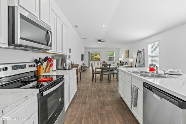 kitchen featuring sink, white cabinetry, appliances with stainless steel finishes, dark hardwood / wood-style flooring, and ceiling fan