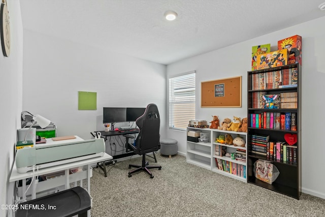 carpeted home office with a textured ceiling