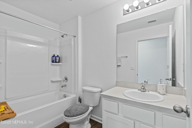 full bathroom featuring toilet, tub / shower combination, a textured ceiling, vanity, and hardwood / wood-style flooring