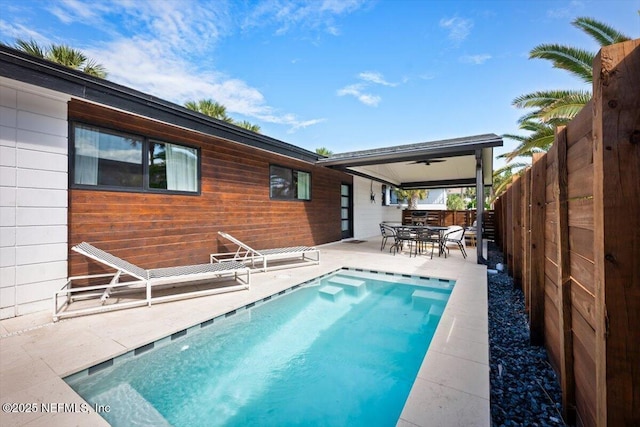 view of swimming pool featuring a patio area and ceiling fan