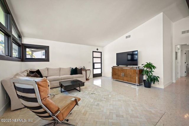 living room with high vaulted ceiling