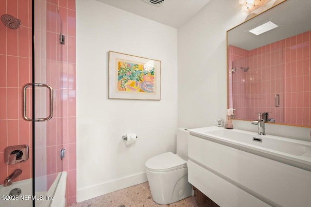 full bathroom featuring vanity, shower / bath combination with glass door, and toilet