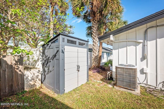 view of outdoor structure with central AC unit and a yard