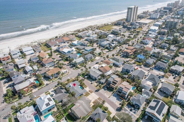 birds eye view of property featuring a view of the beach and a water view