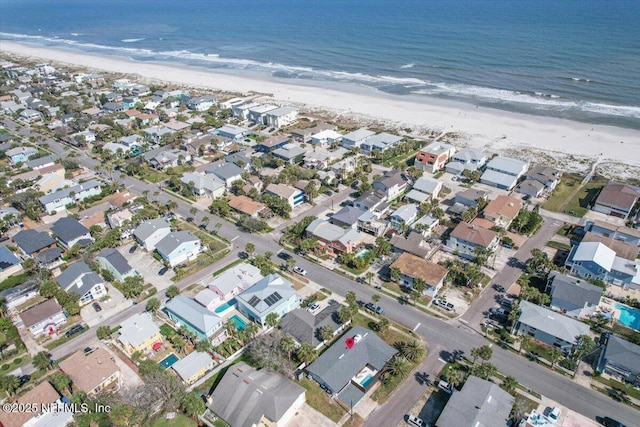 bird's eye view with a water view and a beach view