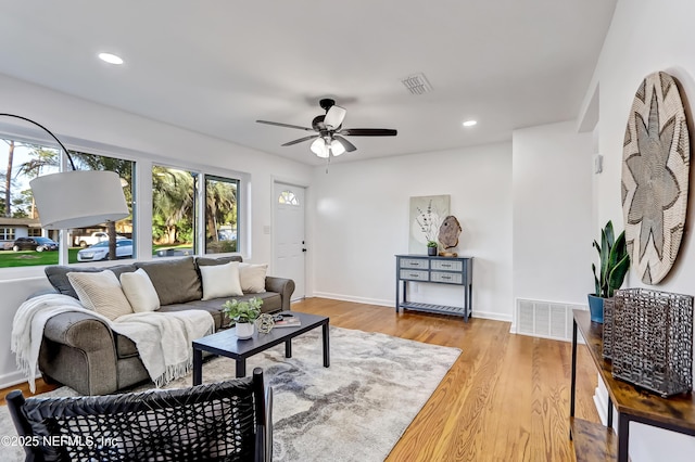 living room featuring light hardwood / wood-style floors and ceiling fan