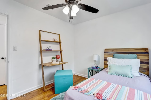 bedroom with ceiling fan and hardwood / wood-style floors