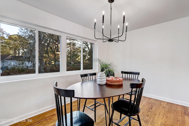 dining space featuring a chandelier and light hardwood / wood-style flooring