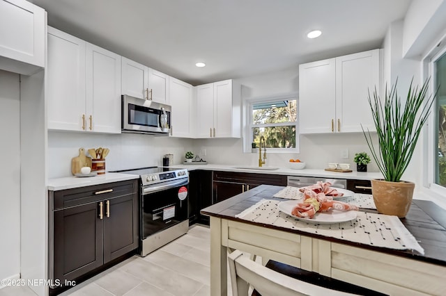 kitchen with white cabinetry, stainless steel appliances, and sink