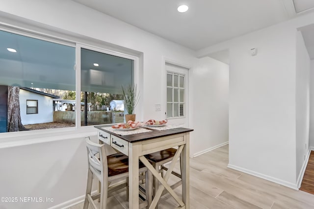 dining space featuring wood-type flooring