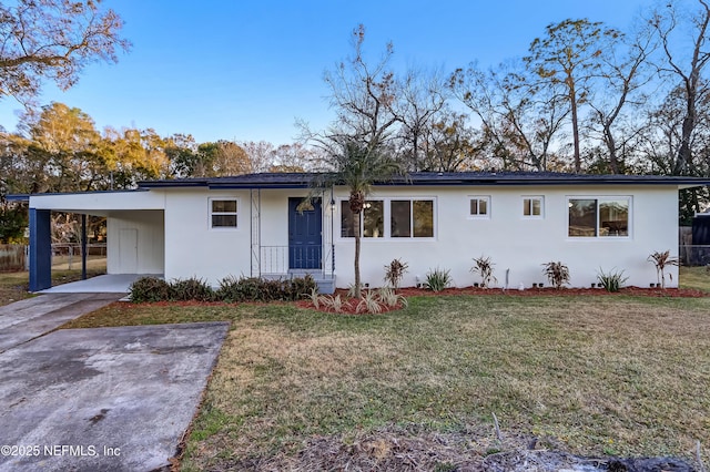 ranch-style house featuring a carport and a front lawn