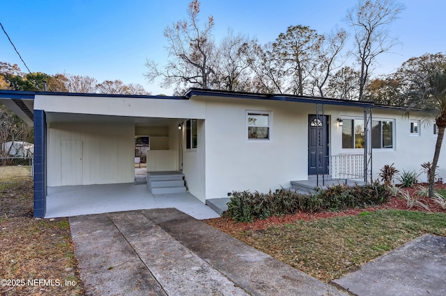 view of front of property featuring a carport