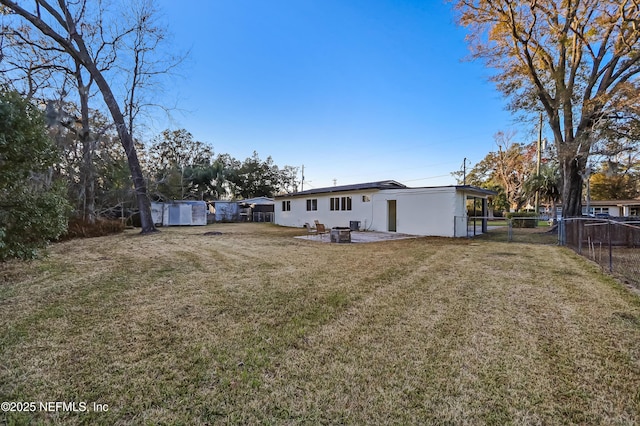 rear view of property featuring a lawn