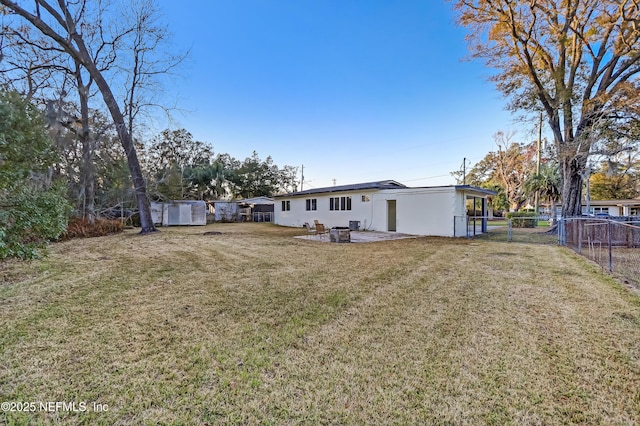 rear view of property with a yard