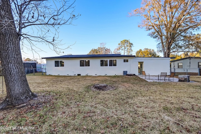 rear view of house with a patio and a yard