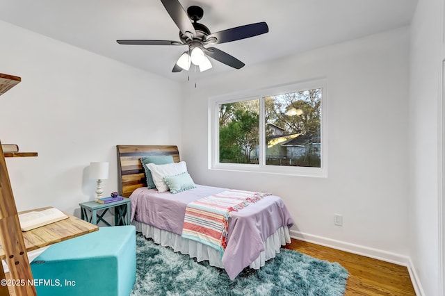 bedroom with ceiling fan and hardwood / wood-style floors