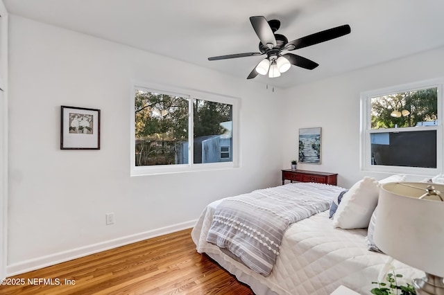 bedroom with hardwood / wood-style flooring and ceiling fan