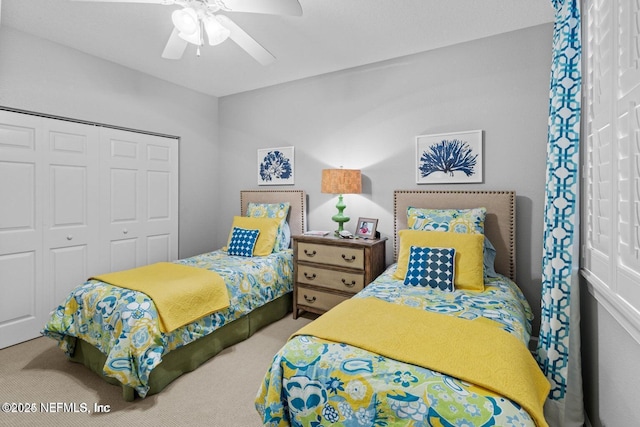 carpeted bedroom featuring ceiling fan and a closet