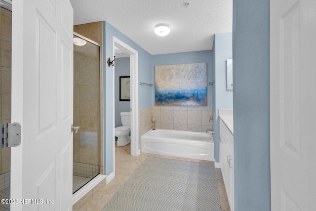 full bathroom with vanity, plus walk in shower, a textured ceiling, tile patterned floors, and toilet