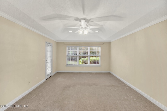 empty room featuring crown molding, a ceiling fan, carpet flooring, a textured ceiling, and baseboards