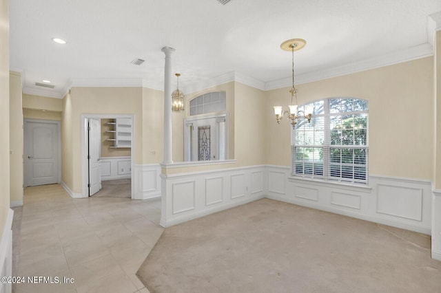 spare room featuring a chandelier, ornamental molding, a wainscoted wall, and light tile patterned floors