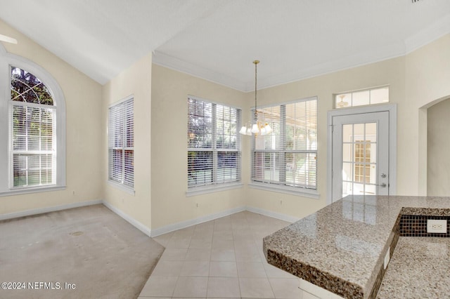 unfurnished dining area with baseboards, arched walkways, ornamental molding, a notable chandelier, and light tile patterned flooring