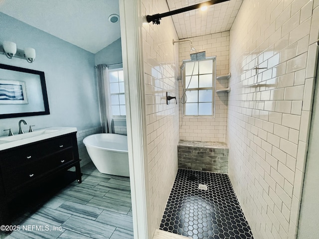 bathroom featuring shower with separate bathtub, vaulted ceiling, and a healthy amount of sunlight