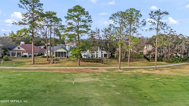 view of home's community with a yard