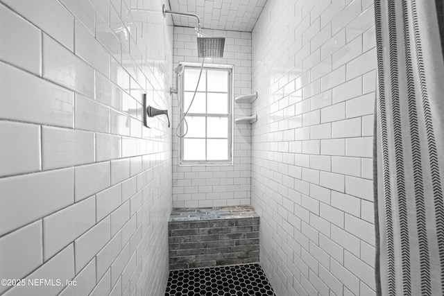 bathroom featuring a tile shower