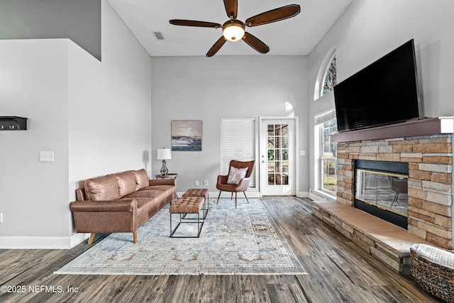 living room featuring hardwood / wood-style floors, a fireplace, and ceiling fan