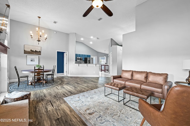 living room featuring wood-type flooring, lofted ceiling, ceiling fan with notable chandelier, and a textured ceiling