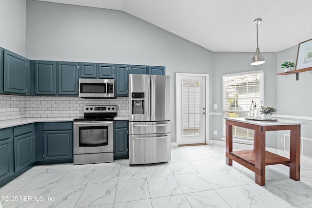 kitchen featuring blue cabinetry, appliances with stainless steel finishes, hanging light fixtures, backsplash, and a textured ceiling