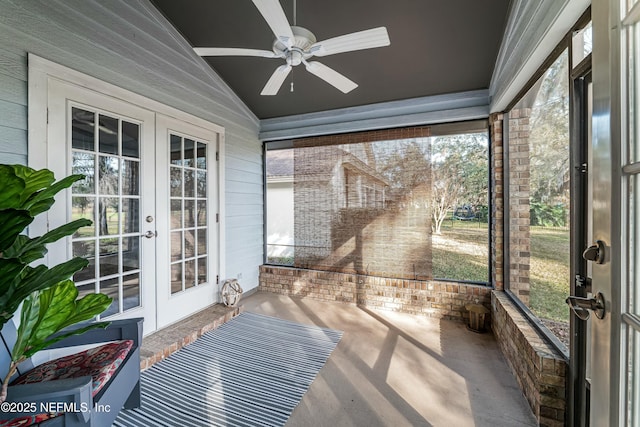 unfurnished sunroom featuring vaulted ceiling, ceiling fan, and french doors