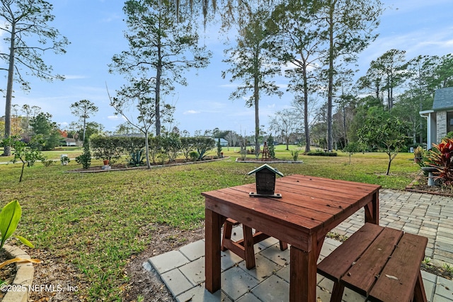 view of community featuring a patio area and a lawn