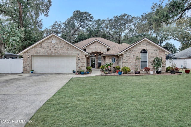 ranch-style house featuring a garage and a front lawn