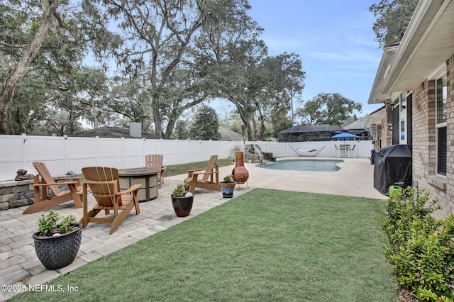 view of yard with a fenced in pool and a patio