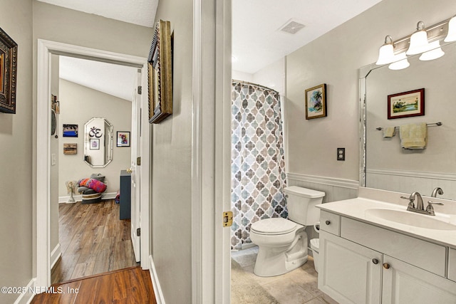 bathroom with vanity, hardwood / wood-style floors, toilet, and walk in shower