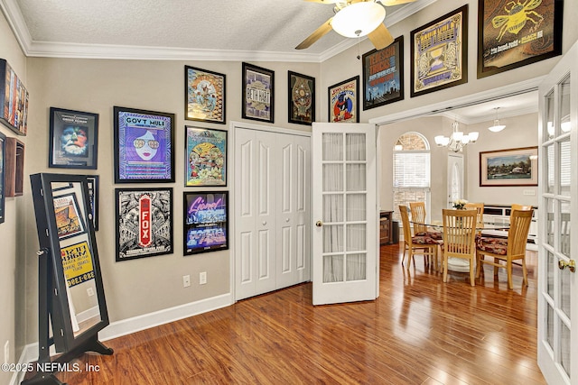 interior space featuring french doors, wood-type flooring, and crown molding