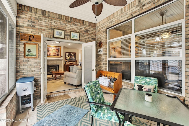 sunroom featuring ceiling fan