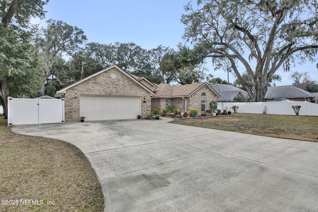 single story home featuring a garage and a front yard