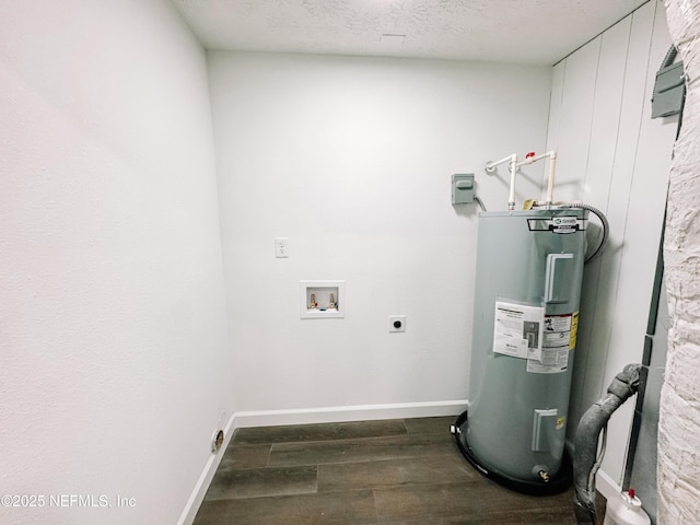 clothes washing area featuring a textured ceiling, dark hardwood / wood-style flooring, washer hookup, hookup for an electric dryer, and water heater