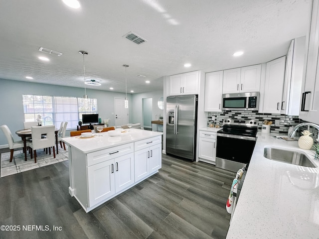 kitchen featuring sink, white cabinets, and appliances with stainless steel finishes