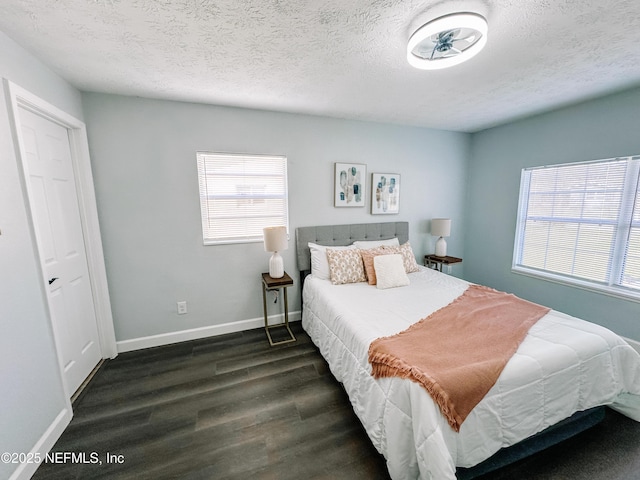 bedroom featuring dark hardwood / wood-style floors and a textured ceiling