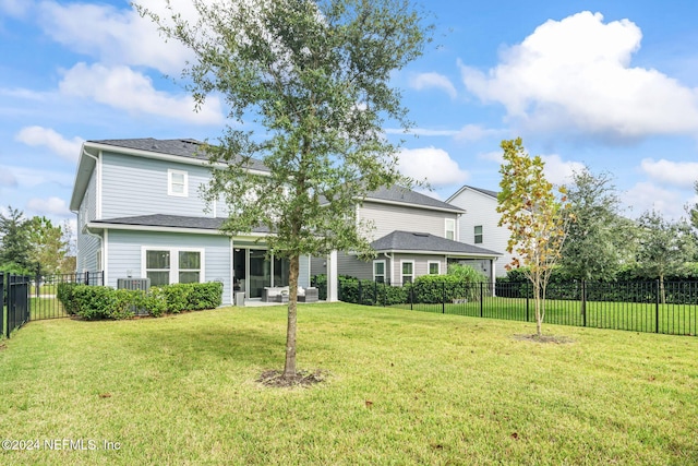 rear view of house with a patio area, a lawn, and central air condition unit